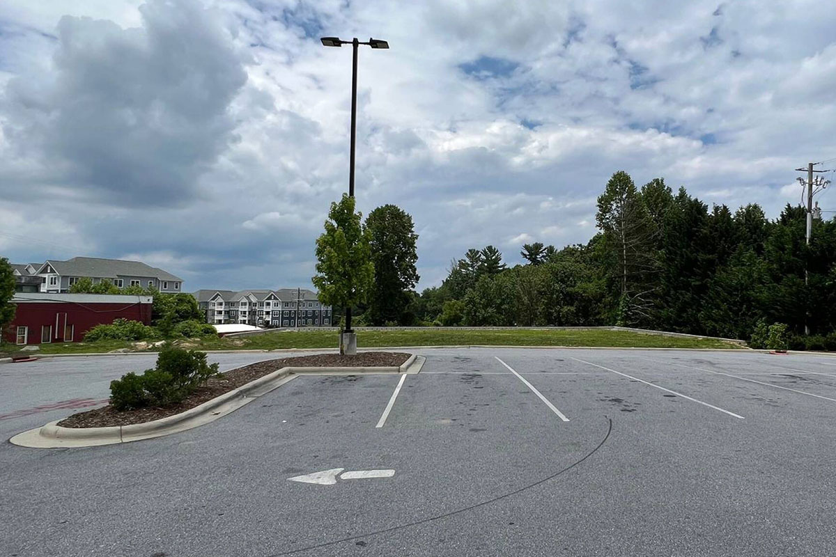 View from parking lot side showing pad and residential development behind